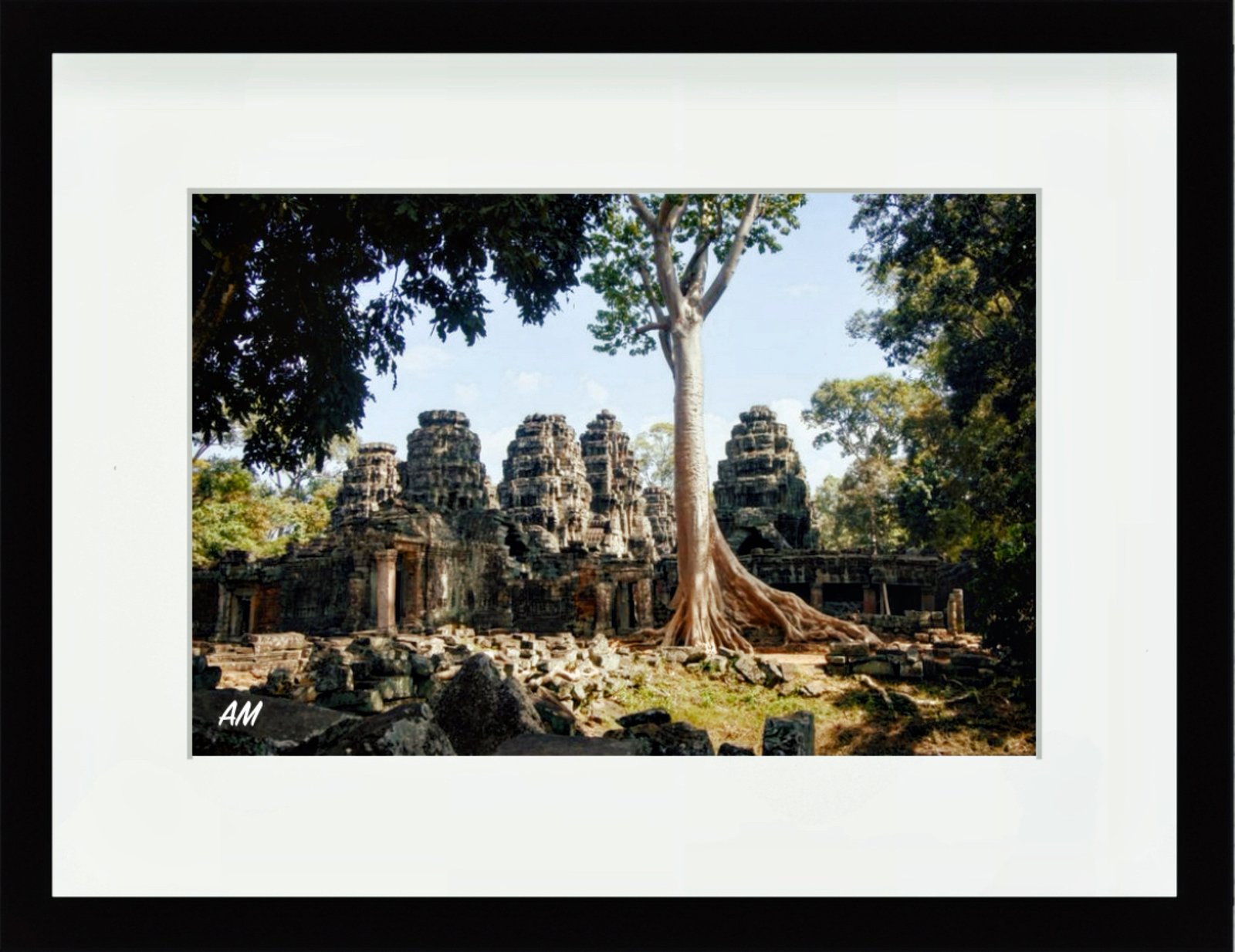 Moss covered crumbling doorway at Banteay Kdei temple framing distant ruins