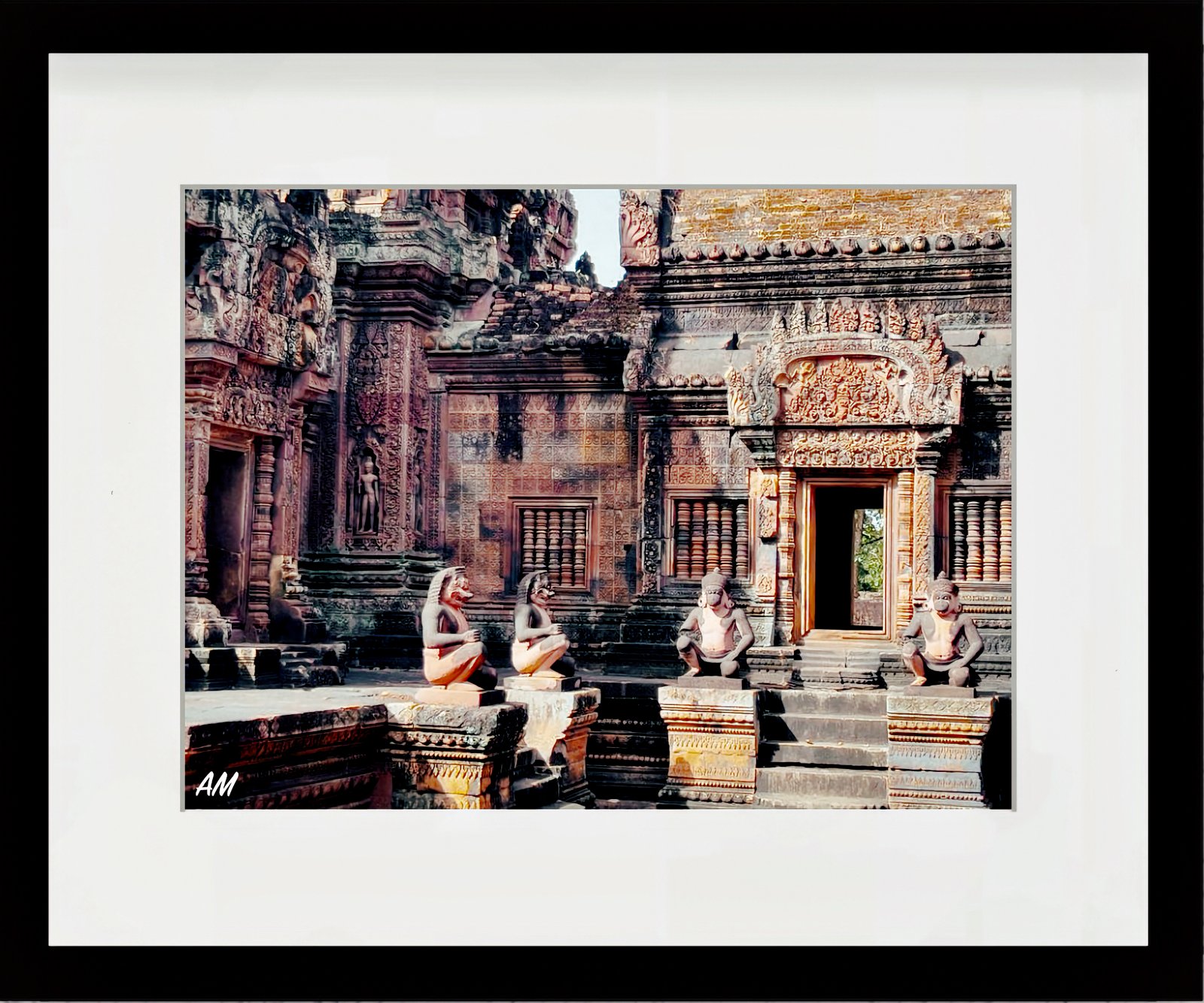 Detailed pink sandstone carvings at Banteay Srei temple glowing in warm light